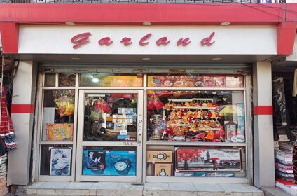 Garland Gift Shop in Udhampur near Bank of India offers a wide range of gifts including watches, perfumes, soft toys, greeting cards, and more.
